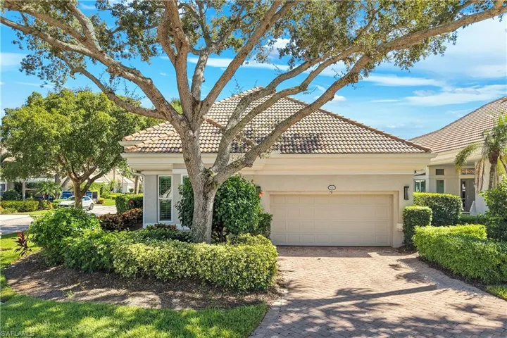 Striking first impression featuring elegant architectural details and beautifully maintained landscaping.