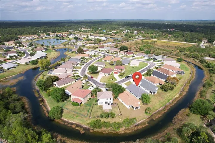 Birds eye view of property with a water view