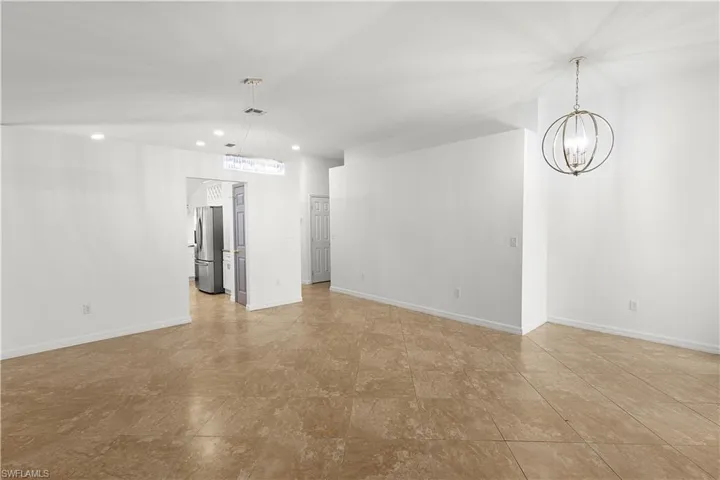 Unfurnished room with an inviting chandelier