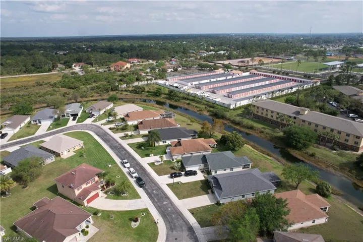 Birds eye view of property with a water view