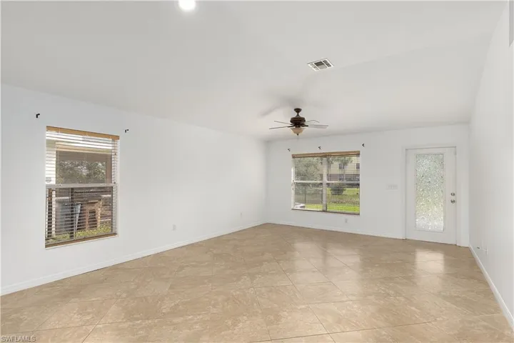 Empty room with a healthy amount of sunlight and ceiling fan