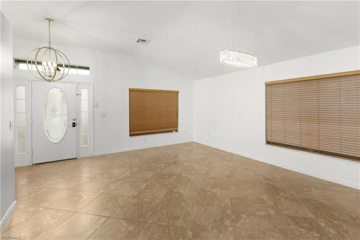 Entrance foyer with a chandelier and vaulted ceiling