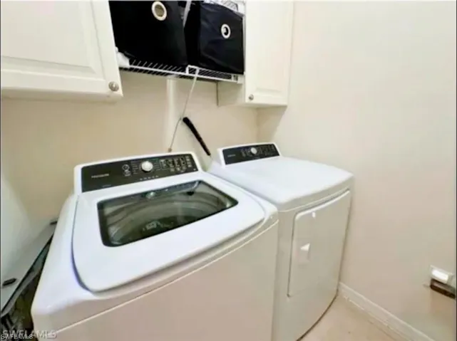 Laundry room with cabinet space and washing machine and clothes dryer