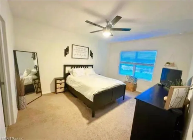 Bedroom with carpet flooring and ceiling fan