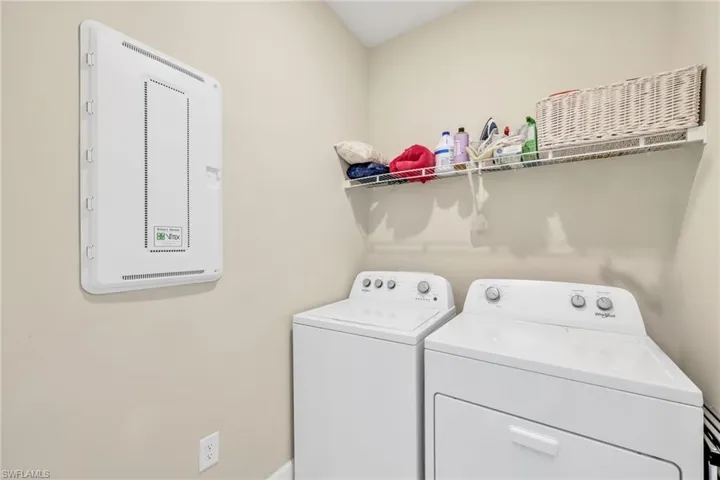 Laundry room featuring separate washer and dryer and baseboards