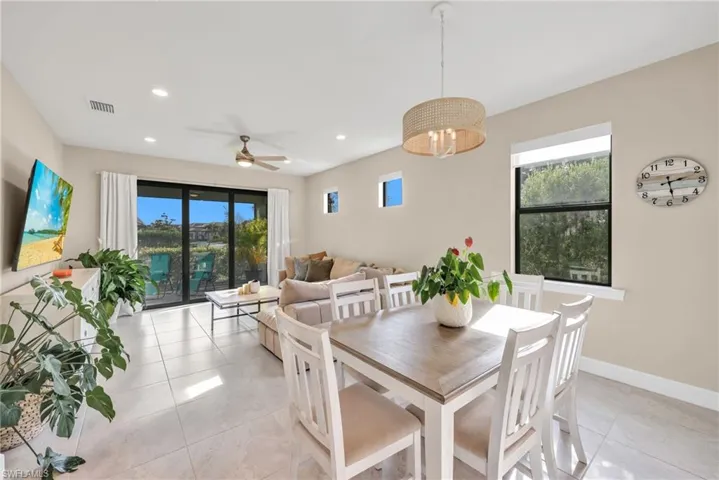Dining area with plenty of natural light, a ceiling fan, recessed lighting, and light tile patterned floors