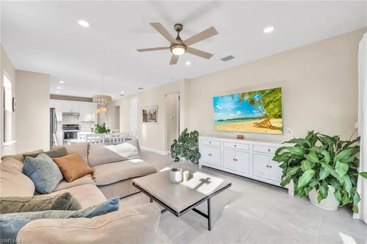 Living area featuring recessed lighting, ceiling fan, and light tile patterned flooring