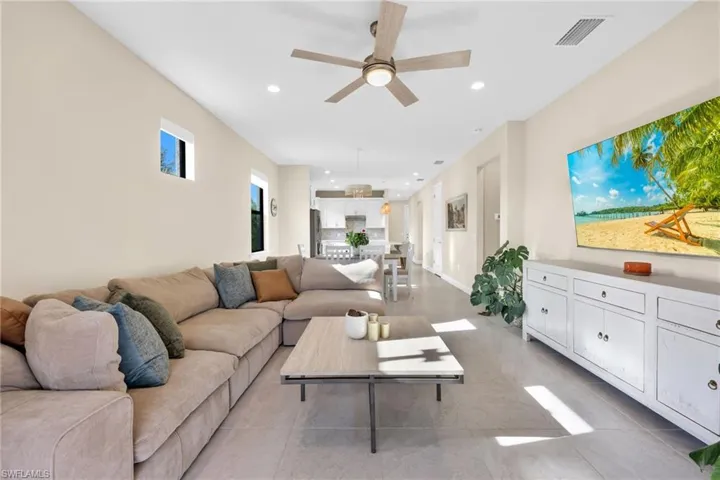 Living area featuring recessed lighting, ceiling fan, and light tile patterned floors
