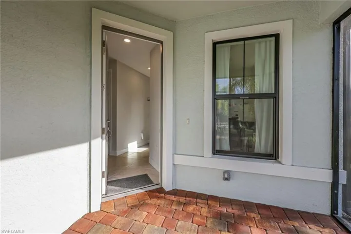 Entrance to property featuring stucco siding