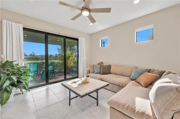 Living area featuring recessed lighting, ceiling fan, and light tile patterned floors