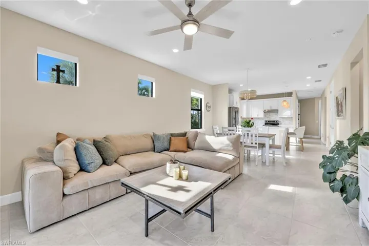 Living room featuring recessed lighting, a ceiling fan, and light tile patterned floors