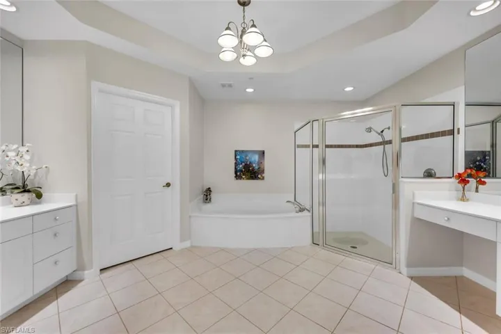 Full bath featuring a garden tub, a shower stall, vanity, recessed lighting, and tile patterned flooring