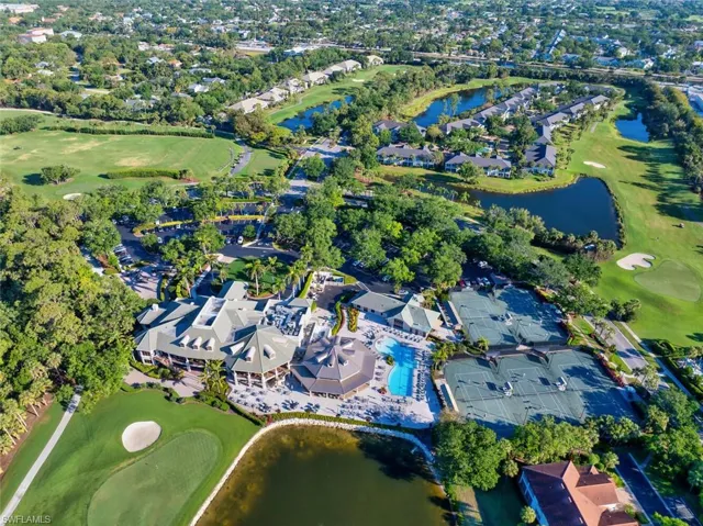 View of property location with a nearby body of water, a golf course
