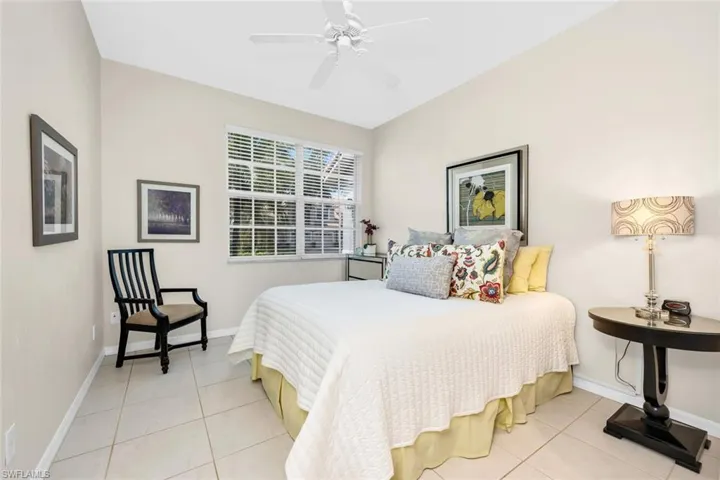 Bedroom featuring tile patterned floors, baseboards, and a ceiling fan