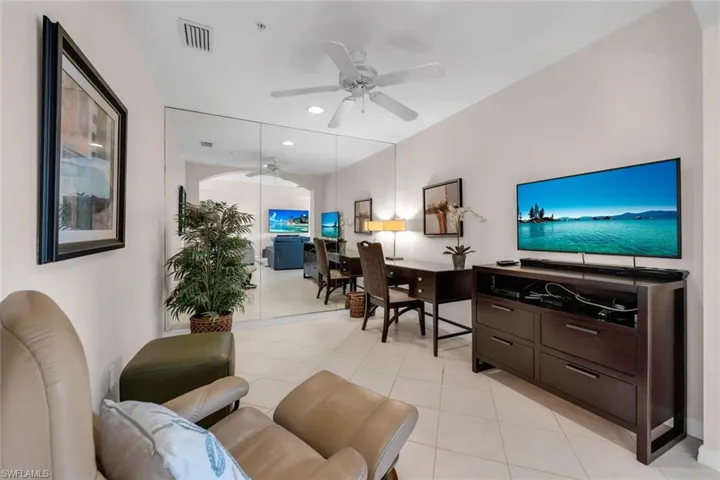 Living room featuring a ceiling fan, light tile patterned flooring, and recessed lighting