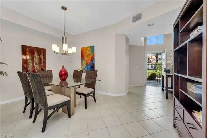Dining space with a chandelier, and light tile patterned flooring