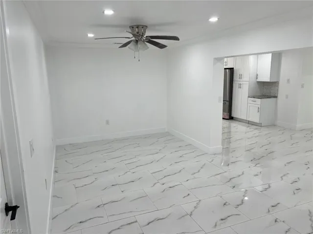 Empty room with light marble finish floors, recessed lighting, a ceiling fan, and crown molding