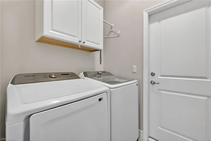 Laundry area featuring cabinet space and washer and clothes dryer