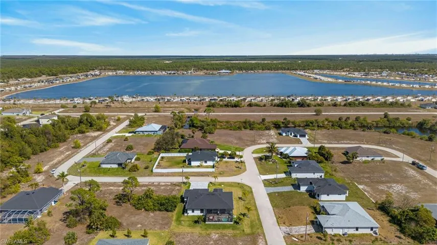 Aerial overview of property's location featuring nearby suburban area and a large body of water