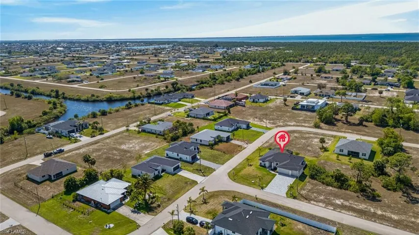 View of property location featuring a nearby body of water and nearby suburban area