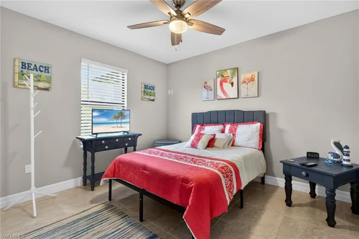 Bedroom featuring a ceiling fan and baseboards
