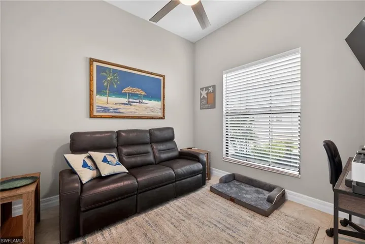Front Den area with a ceiling fan and baseboards