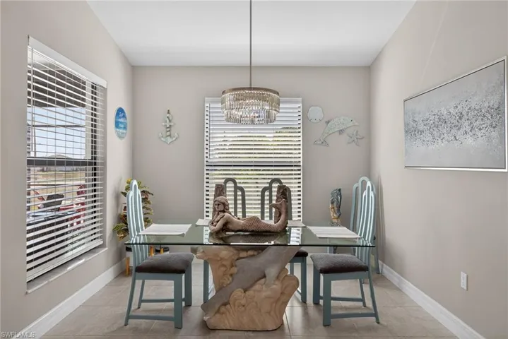 Dining area featuring suspended lighting and light tile floors