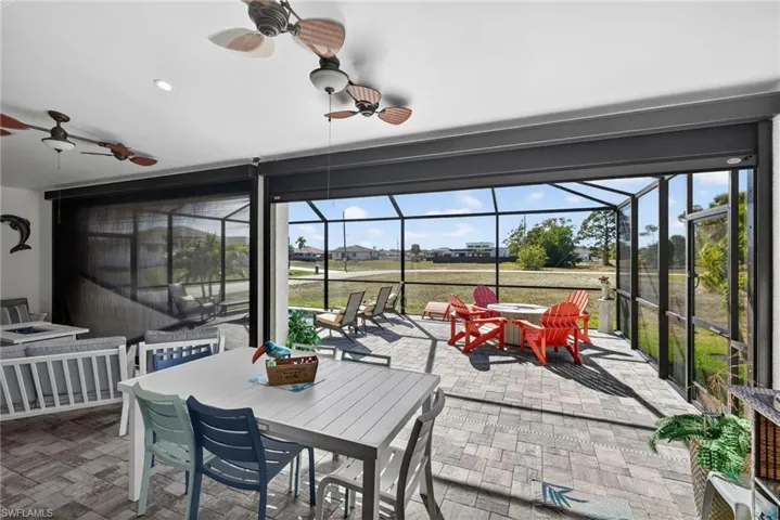 View of patio featuring outdoor dining area, electric hurricane downs on lanai