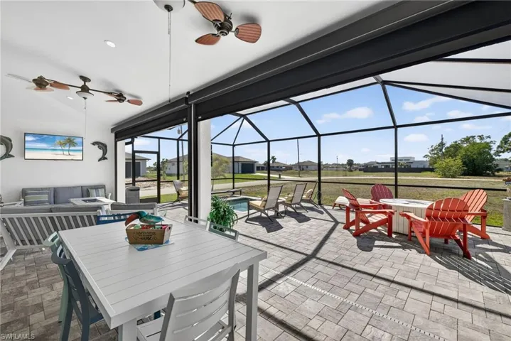 View of patio featuring outdoor dining area, electric hurricane downs on lanai