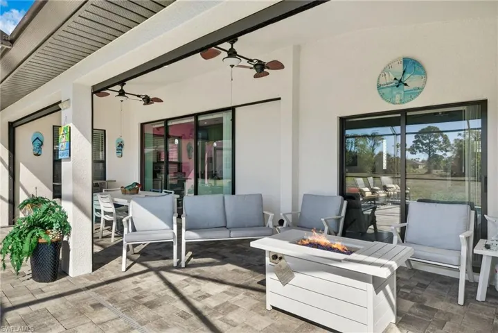 View of patio lanai featuring an outdoor living space with a fire pit and a ceiling fan