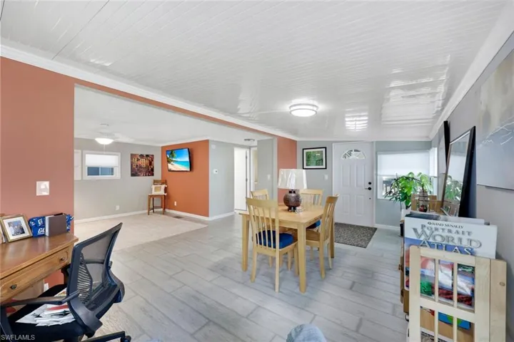 Wood-finish flooring throughout, white paneled ceilings, and recessed lighting