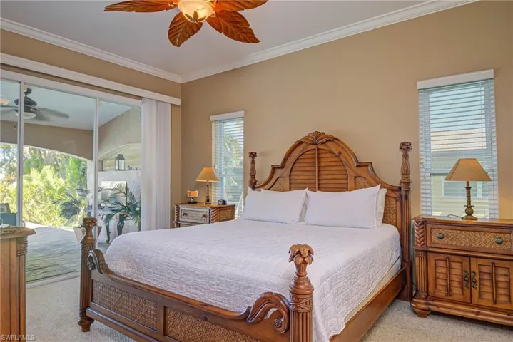 Bedroom featuring ornamental molding, carpet, and access to exterior