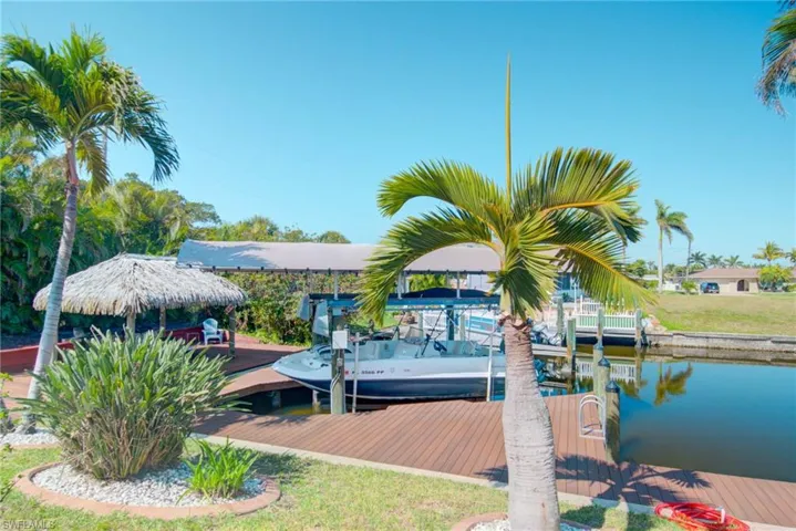 View of dock with boat lift and a water view