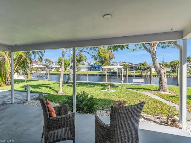 View of patio / terrace with a water view and a dock
