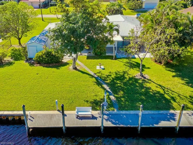 Birds eye view of property with a water view