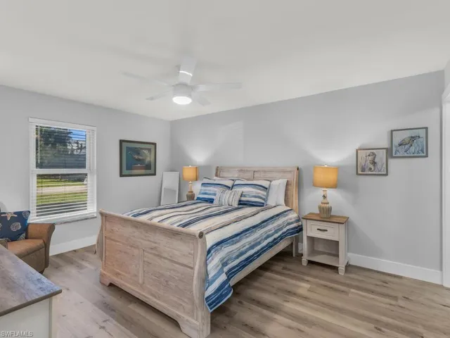 Bedroom featuring light hardwood / wood-style floors and ceiling fan
