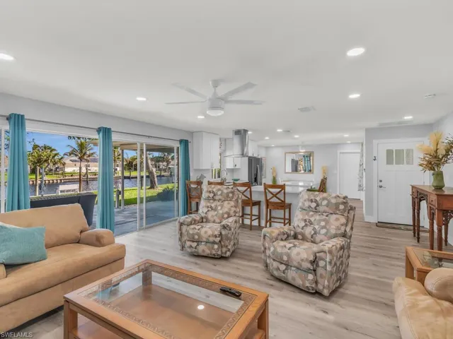 Living room with light hardwood / wood-style flooring and ceiling fan