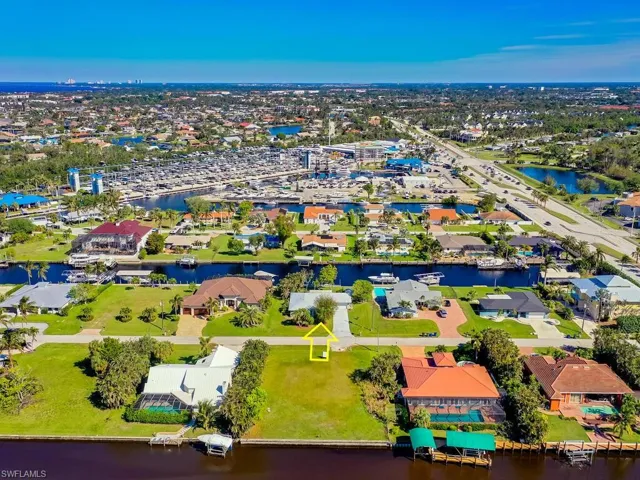Birds eye view of property with a water view