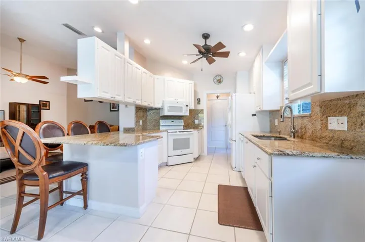 A breakfast bar with seating for four.