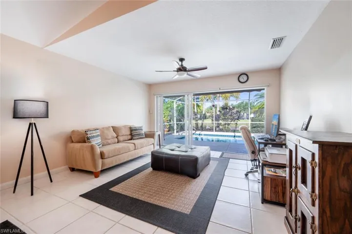 Living Room Area with Sliders to the Lanai. The sliders have a privacy shade.