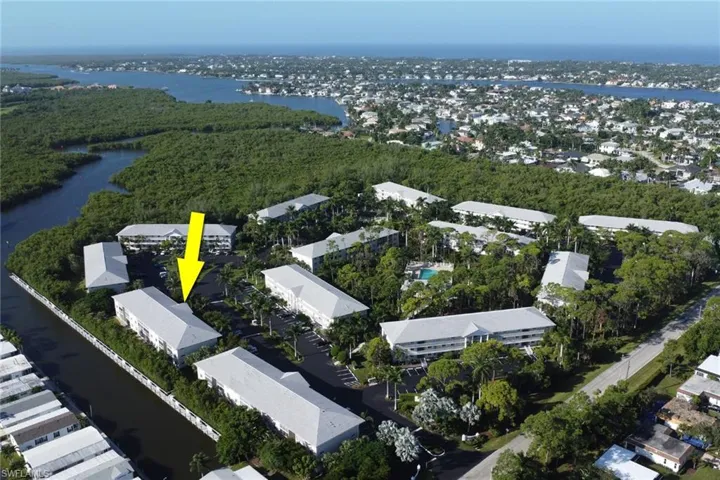 View of property location with a nearby body of water and nearby suburban area