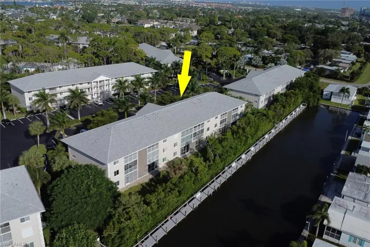Drone / aerial view of a large body of water and apartment complex