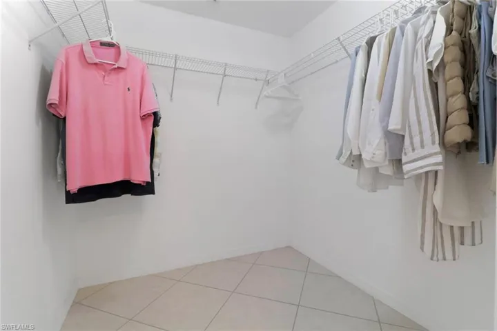 Spacious closet with light tile patterned floors