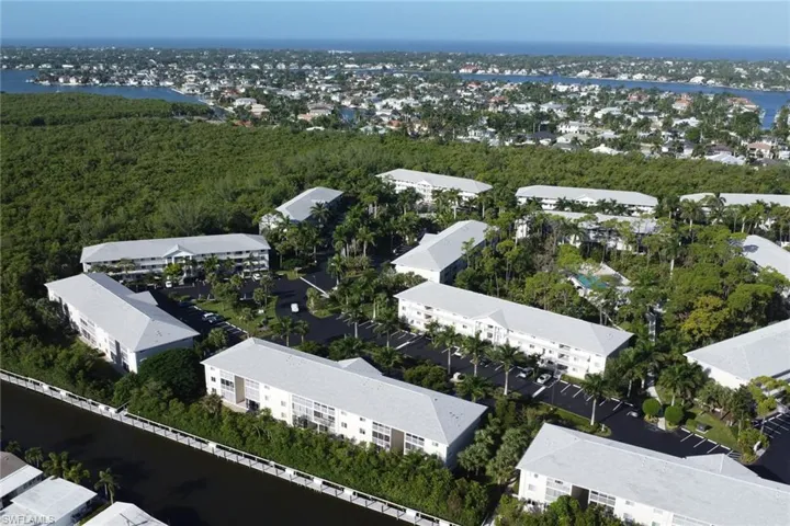 Aerial view of a nearby body of water and a heavily wooded area