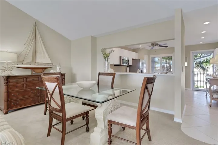 Dining space featuring light colored carpet, recessed lighting, light tile patterned floors, and a ceiling fan