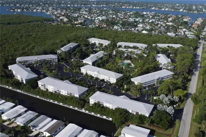 Aerial view of property and surrounding area with a large body of water