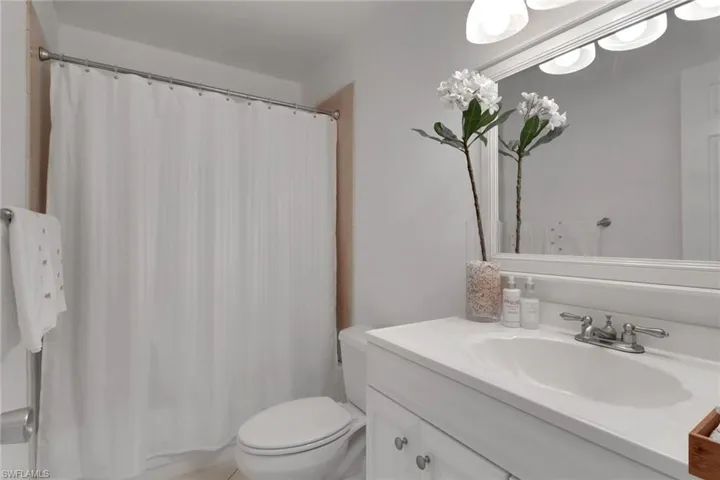 Bathroom with vanity and shower / bathtub combination with curtain