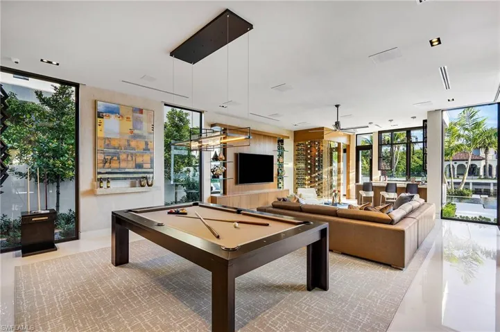 Photos are of a similar home by builder and are for illustrative purposes only. Optional upstairs flex room use as game room with a wall of windows, billiards table, and plenty of natural light.