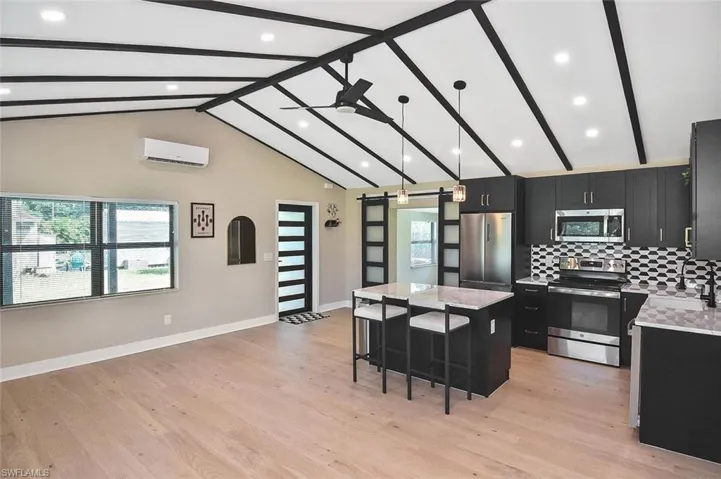 Step inside to a dazzling and thoroughly modern island kitchen accented by a stunning beamed ceiling with recessed lighting.