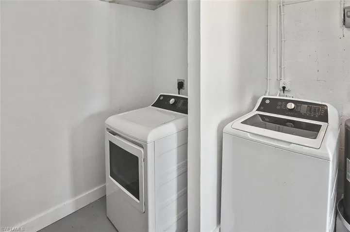 Storage room off of the carport houses the washer & dryer.